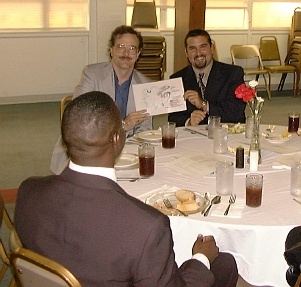 Bill and Randy holding the latest niche theory diagram at the RAM banquet. Drew is in the foreground.