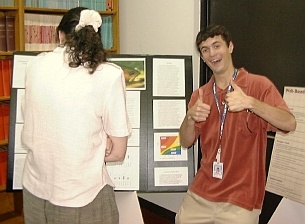 Brian Maskarinec, a student from University of Georgia, is temporarily distracted while explaining his poster to Rebecca Efroymson.