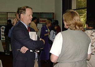 Bill Emanuel, a judge from the University of Virginia, discusses posters with Yetta Jager.