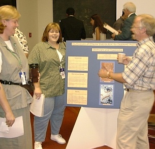 Jenny Alleman, from Delgado Community College, discussing her poster with Yetta Jager and Larry Voorhees.