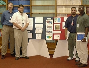Bill Hargrove (CPED) and Forrest Hoffman (ESD), at left, with students Randy and Drew, at right, at the Environmental Sciences student poster session on August 10.